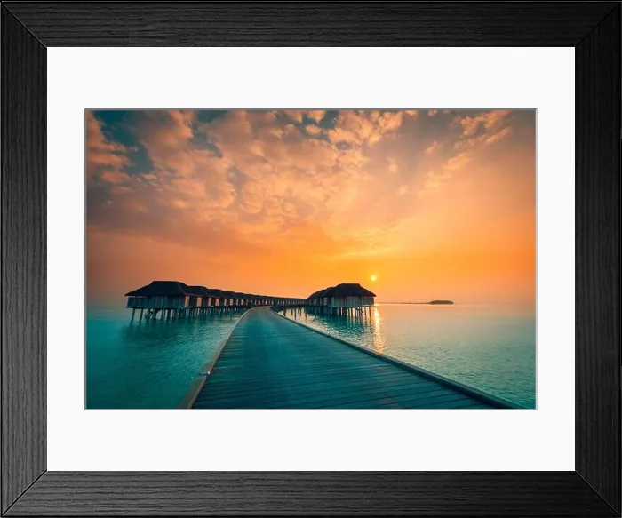 Framed Print : Sunset on Maldives island, luxury water villas resort and wooden pier. Beautiful sky and clouds and beach background for summer vacation holiday Framed Print : Sunset on Maldives island, luxury water villas resort and wooden pier. Beautiful sky and clouds and beach background for summer vacation holiday