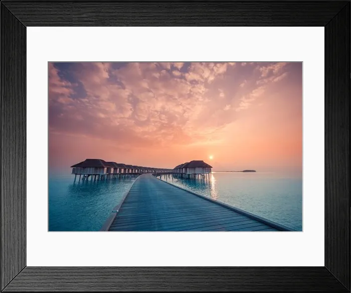 Framed Print : Sunset on Maldives island, luxury water villas resort and wooden pier. Beautiful sky and clouds and beach background for summer vacation holiday Framed Print : Sunset on Maldives island, luxury water villas resort and wooden pier. Beautiful sky and clouds and beach background for summer vacation holiday