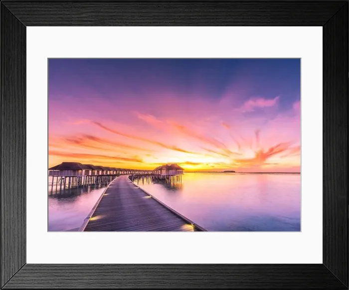 Framed Print : Sunset on Maldives island, luxury water villas resort and wooden pier. Beautiful sky and clouds and beach background for summer vacation holiday Framed Print : Sunset on Maldives island, luxury water villas resort and wooden pier. Beautiful sky and clouds and beach background for summer vacation holiday