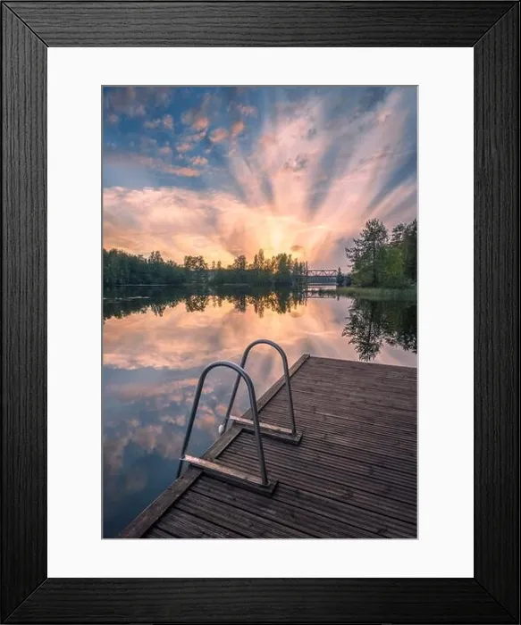 Framed Print : Beautiful sunset in tranquil lake at summer evening in Finland with pier Framed Print : Beautiful sunset in tranquil lake at summer evening in Finland with pier