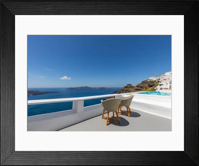 Framed Print : Two chairs on the terrace with sea view. White architecture on Santorini island, Greece. Travel destinations concept, summer holiday, luxury landscape