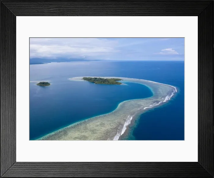 Framed Print : A gorgeous, tropical island is surrounded by reef in Papua New Guinea. This remote area is part of the Coral Triangle due to its marine biodiversity Framed Print : A gorgeous, tropical island is surrounded by reef in Papua New Guinea. This remote area is part of the Coral Triangle due to its marine biodiversity