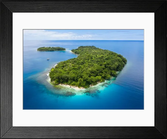 Framed Print : A gorgeous, tropical island is surrounded by reef in Papua New Guinea. This remote area is part of the Coral Triangle due to its marine biodiversity Framed Print : A gorgeous, tropical island is surrounded by reef in Papua New Guinea. This remote area is part of the Coral Triangle due to its marine biodiversity