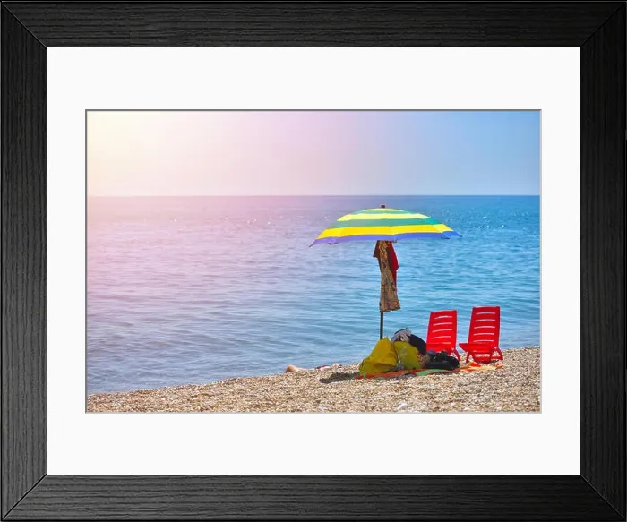 Framed Print : Pair of sun loungers and a beach umbrella on a deserted beach; perfect vacation concept Framed Print : Pair of sun loungers and a beach umbrella on a deserted beach; perfect vacation concept