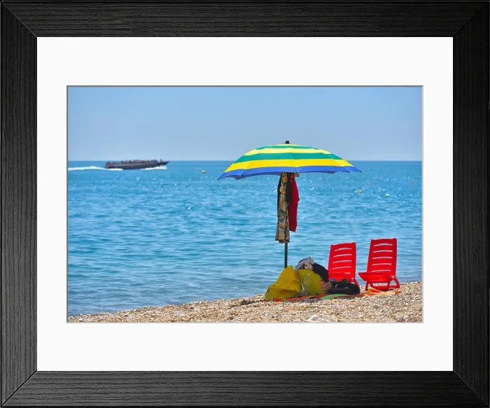 Framed Print : Pair of sun loungers and a beach umbrella on a deserted beach; perfect vacation concept Framed Print : Pair of sun loungers and a beach umbrella on a deserted beach; perfect vacation concept