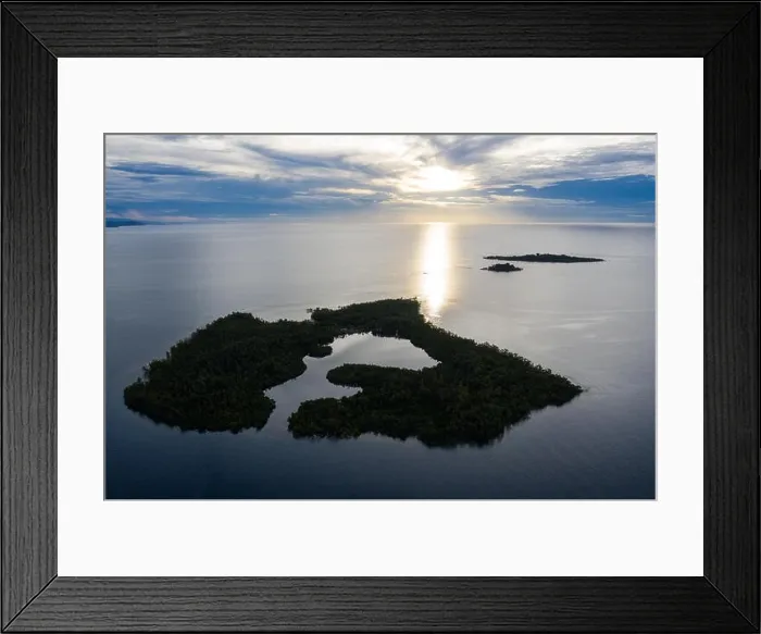 Framed Print : Sunrise illuminates a remote island and lagoon off the coast of New Britain, Papua New Guinea. This area is home to extraordinary marine biodiversity Framed Print : Sunrise illuminates a remote island and lagoon off the coast of New Britain, Papua New Guinea. This area is home to extraordinary marine biodiversity