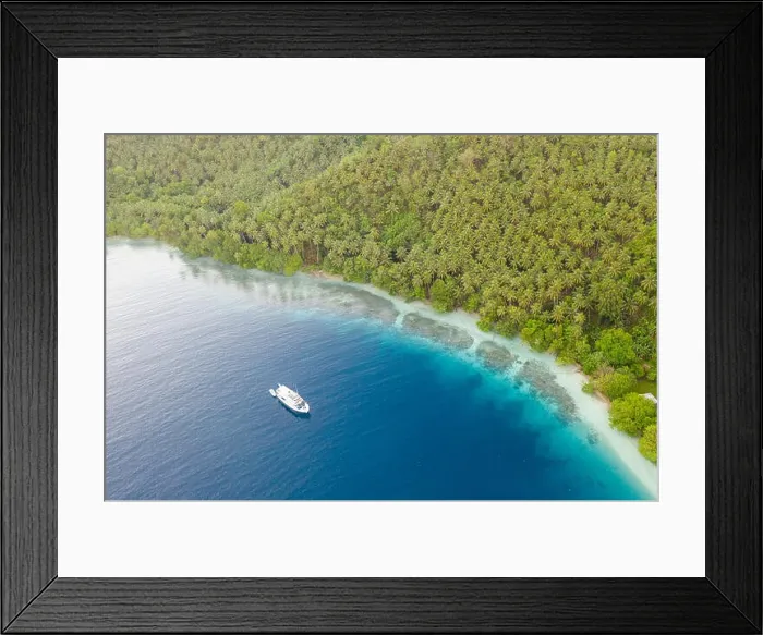 Framed Print : A small dive boat is anchored off the coast of Papua New Guinea. This tropical area is part of the Coral Triangle due to its high marine biodiversity Framed Print : A small dive boat is anchored off the coast of Papua New Guinea. This tropical area is part of the Coral Triangle due to its high marine biodiversity