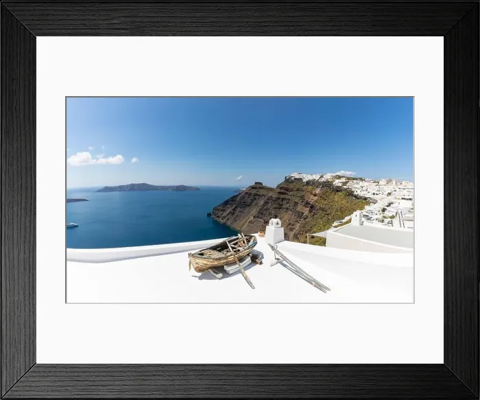Framed Print : Old wooden boat on the white rooftops of caldera in Santorini, Greece. Amazing summer landscape, travel adventure, sea view over white architecture Framed Print : Old wooden boat on the white rooftops of caldera in Santorini, Greece. Amazing summer landscape, travel adventure, sea view over white architecture