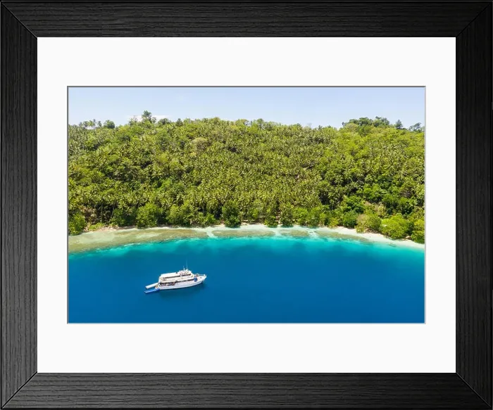 Framed Print : A small dive boat is anchored off the coast of Papua New Guinea. This tropical area is part of the Coral Triangle due to its high marine biodiversity Framed Print : A small dive boat is anchored off the coast of Papua New Guinea. This tropical area is part of the Coral Triangle due to its high marine biodiversity