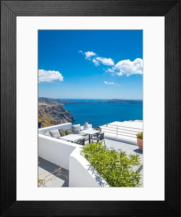 Framed Print : Chairs and table on the terrace. White architecture on Santorini island, Greece. Beautiful view on the sea, vertical banner background. Luxury travel Framed Print : Chairs and table on the terrace. White architecture on Santorini island, Greece. Beautiful view on the sea, vertical banner background. Luxury travel