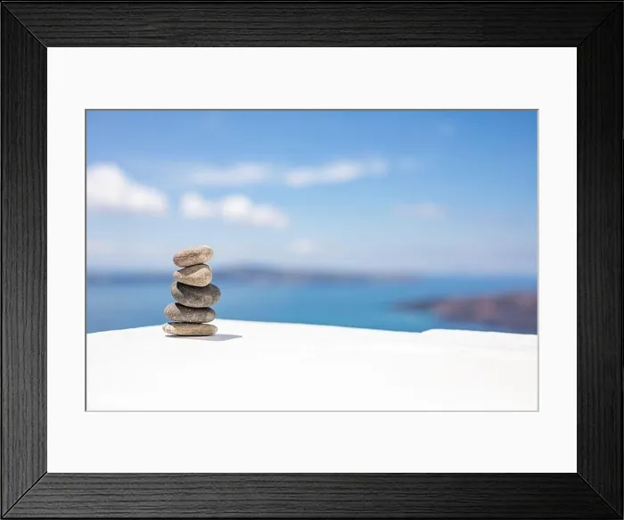 Framed Print : Stones balance, pebbles stack on seascape view. Relaxing concept, white and blue colors Framed Print : Stones balance, pebbles stack on seascape view. Relaxing concept, white and blue colors