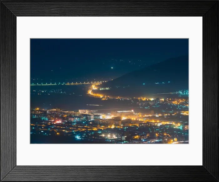 Framed Print : Gori, Shida Kartli Region, Georgia. Cityscape With Night Streets In Bright Yellow Evening Illumination In Twilight. Aerial View Of City Framed Print : Gori, Shida Kartli Region, Georgia. Cityscape With Night Streets In Bright Yellow Evening Illumination In Twilight. Aerial View Of City