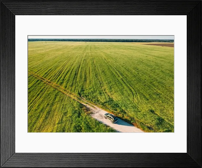 Framed Print : Aerial view of car SUV parked near countryside road in field rural landscape. Bird's-eye drone view of car SUV parked near countryside road in summer Framed Print : Aerial view of car SUV parked near countryside road in field rural landscape. Bird's-eye drone view of car SUV parked near countryside road in summer