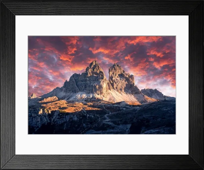 Framed Print : Dramatic evening landscape with Three peaks of Lavaredo mountains, glowing road and pink sunset sky Framed Print : Dramatic evening landscape with Three peaks of Lavaredo mountains, glowing road and pink sunset sky