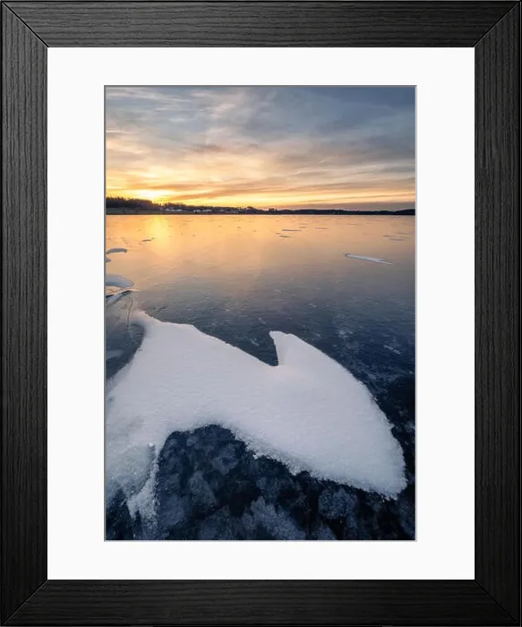 Framed Print : Scenic winter landscape with frozen lake and water at evening sunset in Finland Framed Print : Scenic winter landscape with frozen lake and water at evening sunset in Finland