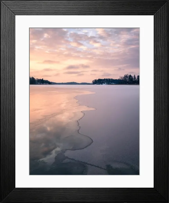 Framed Print : Scenic winter landscape with frozen lake and water at evening sunset in Finland Framed Print : Scenic winter landscape with frozen lake and water at evening sunset in Finland