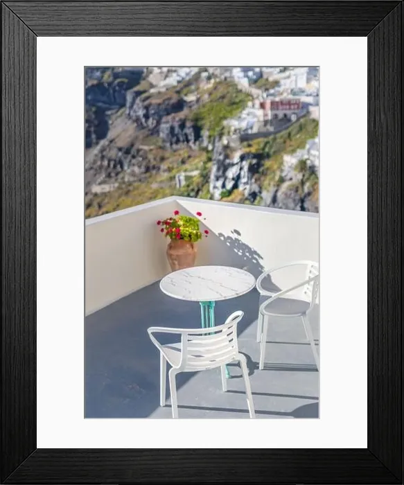 Framed Print : Romantic two chairs and a table on the terrace, Santorini island Greece. Summer vibes with white architecture and sea view. Luxury travel background Framed Print : Romantic two chairs and a table on the terrace, Santorini island Greece. Summer vibes with white architecture and sea view. Luxury travel background