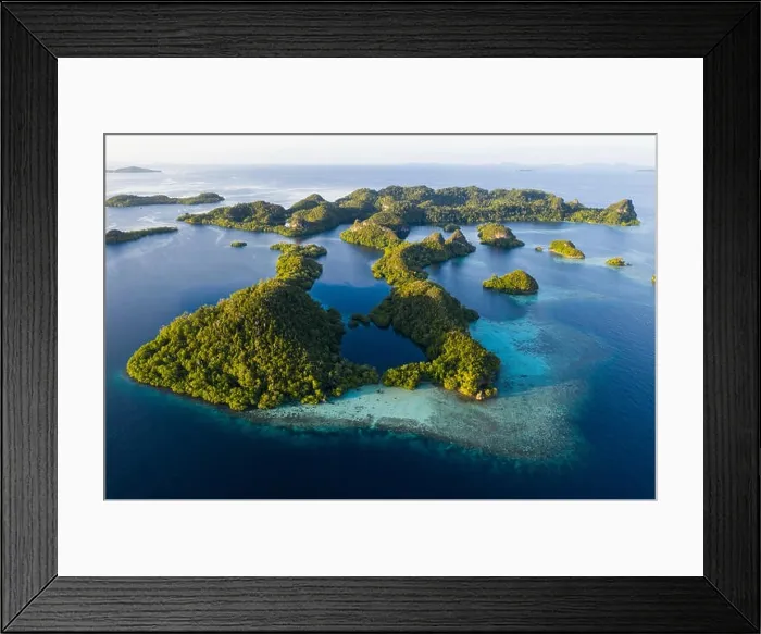 Framed Print : An aerial view of islands in Raja Ampat. This area is the heart of marine biodiversity and is a popular destination for scuba divers and snorkelers Framed Print : An aerial view of islands in Raja Ampat. This area is the heart of marine biodiversity and is a popular destination for scuba divers and snorkelers