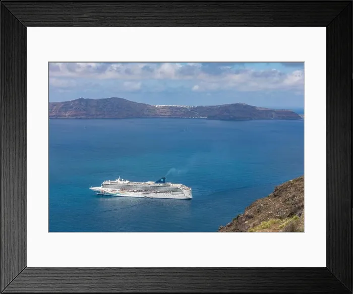 Framed Print : 10.05.19. - Santorini, Greece: Norwegian Jade cruise ship in Santorini sea bay, Blue water with volcanic cliffs over the horizon. Luxury cruiser Fira