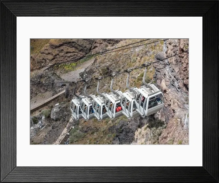 Framed Print : Santorini cable car, transporting tourist above the cliffs to Fira port. Summer vacation Framed Print : Santorini cable car, transporting tourist above the cliffs to Fira port. Summer vacation