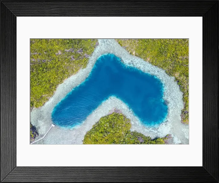 Framed Print : Limestone islands surround a uniquely shaped lagoon in Raja Ampat, Indonesia. This remote, tropical region is known for its marine biodiversity Framed Print : Limestone islands surround a uniquely shaped lagoon in Raja Ampat, Indonesia. This remote, tropical region is known for its marine biodiversity