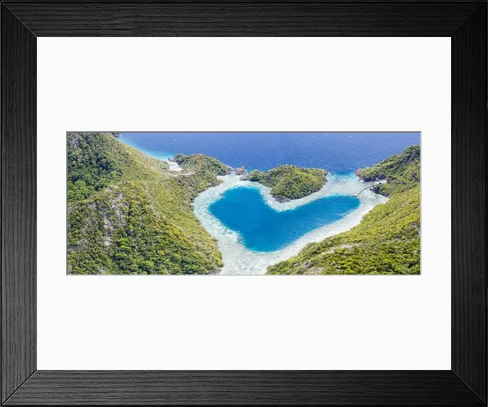 Framed Print : Limestone islands surround a uniquely shaped lagoon in Raja Ampat, Indonesia. This remote, tropical region is known for its marine biodiversity Framed Print : Limestone islands surround a uniquely shaped lagoon in Raja Ampat, Indonesia. This remote, tropical region is known for its marine biodiversity