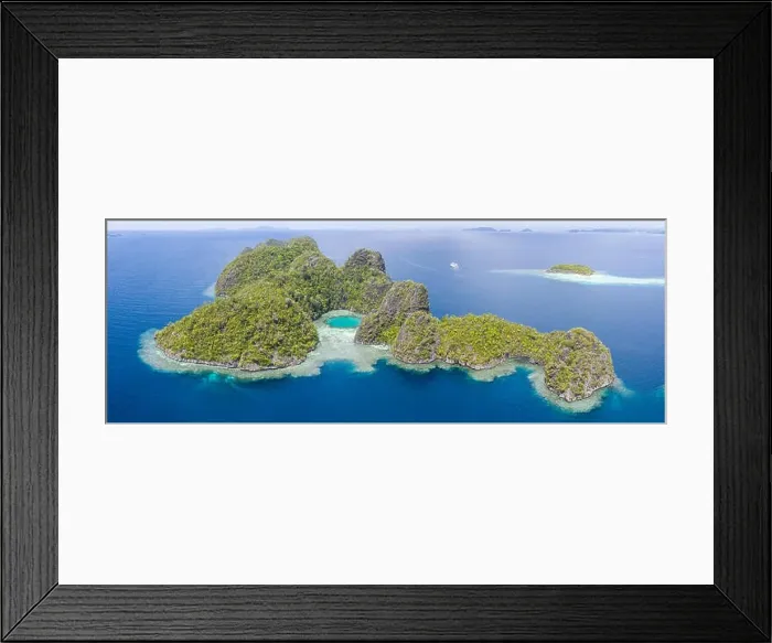 Framed Print : Healthy coral reefs surround the limestone islands found in Raja Ampat, Indonesia. This remote, tropical region is known for its marine biodiversity Framed Print : Healthy coral reefs surround the limestone islands found in Raja Ampat, Indonesia. This remote, tropical region is known for its marine biodiversity