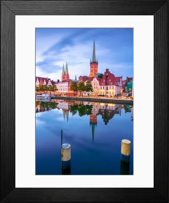 Framed Print : Lubeck, Germany. Cityscape image of riverside Lubeck with reflection of the city in Trave River at sunset Framed Print : Lubeck, Germany. Cityscape image of riverside Lubeck with reflection of the city in Trave River at sunset