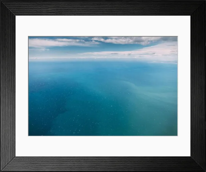 Framed Print : Aerial View From High Altitude Flight Of Aircraft On Sea Ocean Surface. Natural Sea Background Framed Print : Aerial View From High Altitude Flight Of Aircraft On Sea Ocean Surface. Natural Sea Background