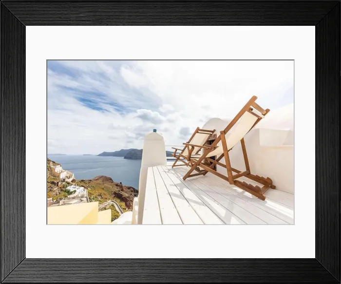 Framed Print : Relax on Santorini. View on caldera and sea from balcony, Santorini, Greece. White resort terrace with chaise lounge concept. Cloudy morning in Oia Framed Print : Relax on Santorini. View on caldera and sea from balcony, Santorini, Greece. White resort terrace with chaise lounge concept. Cloudy morning in Oia
