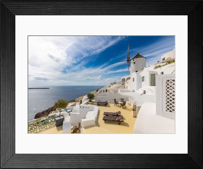 Framed Print : Summer travel destinations. Picturesque cityscape of Oia village in Santorini island located volcanic caldera. Traditional windmills, luxury vacation Framed Print : Summer travel destinations. Picturesque cityscape of Oia village in Santorini island located volcanic caldera. Traditional windmills, luxury vacation