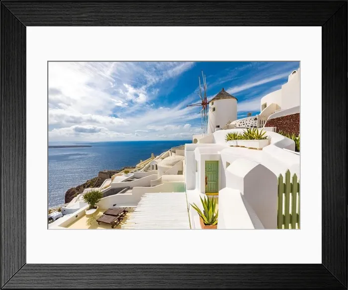 Framed Print : Summer travel destinations. Picturesque cityscape of Oia village in Santorini island located volcanic caldera. Traditional windmills, luxury vacation Framed Print : Summer travel destinations. Picturesque cityscape of Oia village in Santorini island located volcanic caldera. Traditional windmills, luxury vacation