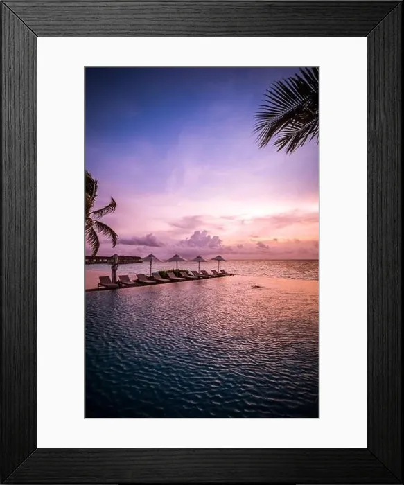 Framed Print : Beautiful poolside and sunset sky with palm trees. Luxury tropical beach landscape, infinity swimming pool, deck chairs and loungers under umbrella Framed Print : Beautiful poolside and sunset sky with palm trees. Luxury tropical beach landscape, infinity swimming pool, deck chairs and loungers under umbrella