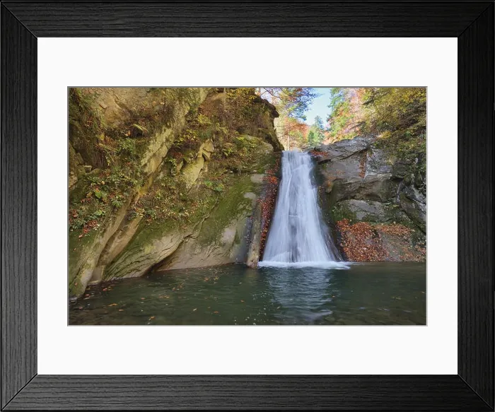 Framed Print : Autumn waterfall and creek woods with yellow trees foliage and rocks in forest mountain