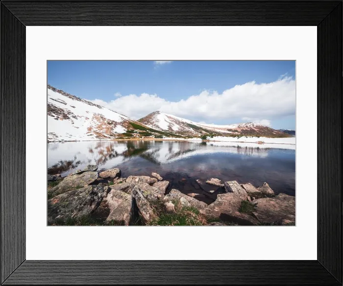 Framed Print : Spring mountain lake with clear water and red stones. Picturesque winter landscape with snowy hills under a blue sky Framed Print : Spring mountain lake with clear water and red stones. Picturesque winter landscape with snowy hills under a blue sky