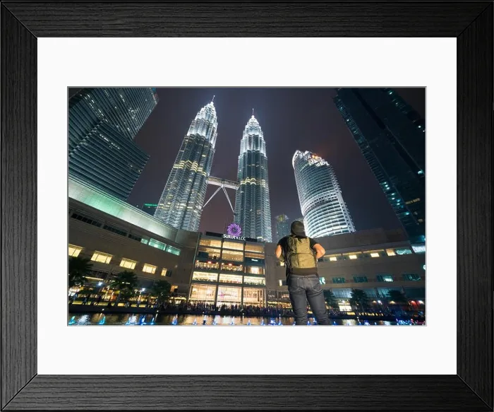 Framed Print : Young Asian man traveler wearing casual with backpack bag enjoy amazing weekends. Looking away to building in Kuala Lumpur, Malaysia. Asia Framed Print : Young Asian man traveler wearing casual with backpack bag enjoy amazing weekends. Looking away to building in Kuala Lumpur, Malaysia. Asia