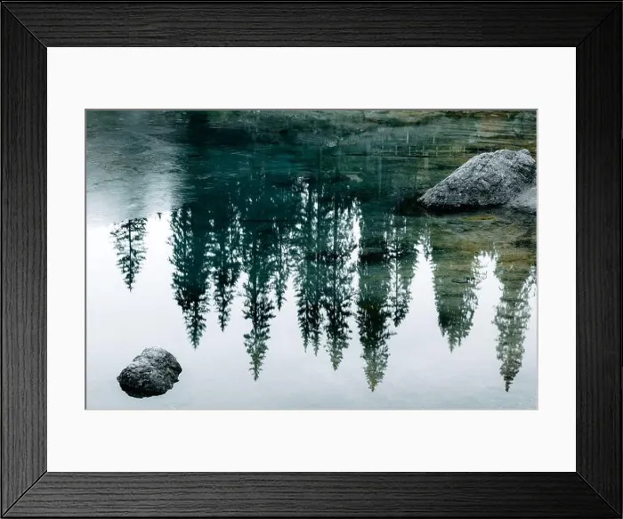 Framed Print : Turquoise frozen water of Lake Carezza (Karersee) in Western Dolomites, Italy. Beautiful close up view with stones and pines reflection Framed Print : Turquoise frozen water of Lake Carezza (Karersee) in Western Dolomites, Italy. Beautiful close up view with stones and pines reflection