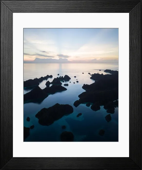 Framed Print : Remote limestone islands form a maze in a tropical lagoon in Raja Ampat, Indonesia. This diverse region is known as the heart of the Coral Triangle Framed Print : Remote limestone islands form a maze in a tropical lagoon in Raja Ampat, Indonesia. This diverse region is known as the heart of the Coral Triangle