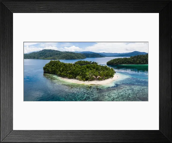 Framed Print : A remote limestone island is surrounded by healthy reef in Raja Ampat, Indonesia. This diverse region is known as the heart of the Coral Triangle Framed Print : A remote limestone island is surrounded by healthy reef in Raja Ampat, Indonesia. This diverse region is known as the heart of the Coral Triangle