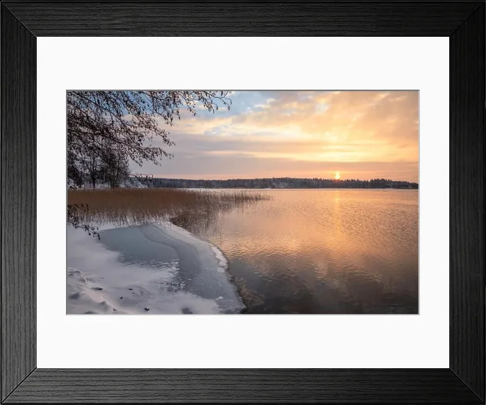 Framed Print : Scenic winter landscape with sunset at icy and peaceful lake in Finland Framed Print : Scenic winter landscape with sunset at icy and peaceful lake in Finland