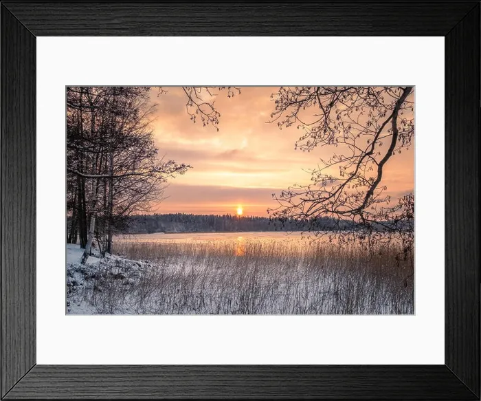 Framed Print : Scenic winter landscape with sunset at icy and peaceful lake in Finland Framed Print : Scenic winter landscape with sunset at icy and peaceful lake in Finland