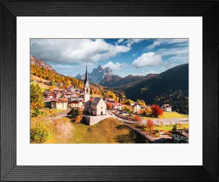 Framed Print : Aerial drone flight over San Lorenzo Catholic church in Selva di Cadore village. Biautiful small city in autumn Dolomites mountains Framed Print : Aerial drone flight over San Lorenzo Catholic church in Selva di Cadore village. Biautiful small city in autumn Dolomites mountains