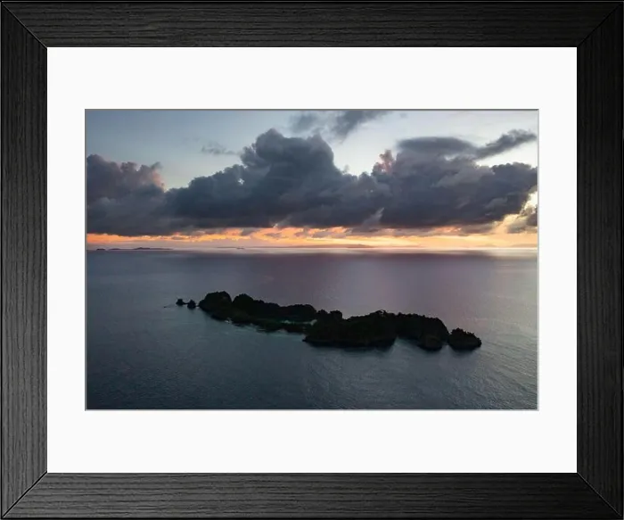 Framed Print : A calm dawn silhouettes beautiful limestone islands in Raja Ampat, Indonesia. This remote, tropical area is known as the heart of the Coral Triangle Framed Print : A calm dawn silhouettes beautiful limestone islands in Raja Ampat, Indonesia. This remote, tropical area is known as the heart of the Coral Triangle
