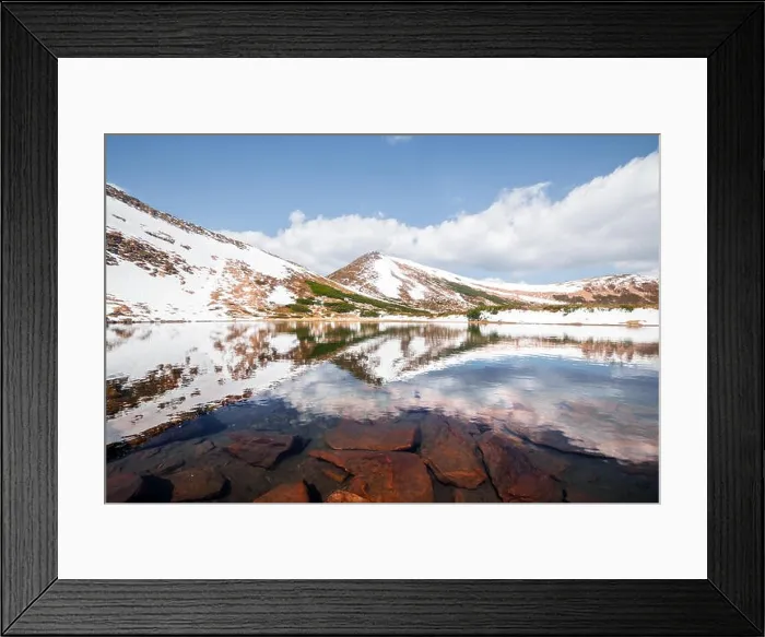 Framed Print : Spring mountain lake with clear water and red stones. Picturesque winter landscape with snowy hills under a blue sky Framed Print : Spring mountain lake with clear water and red stones. Picturesque winter landscape with snowy hills under a blue sky