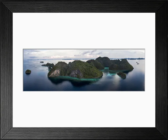 Framed Print : Limestone islands in Raja Ampat, Indonesia, are surrounded by healthy coral reefs. This biodiverse region is known as the heart of the Coral Triangle Framed Print : Limestone islands in Raja Ampat, Indonesia, are surrounded by healthy coral reefs. This biodiverse region is known as the heart of the Coral Triangle