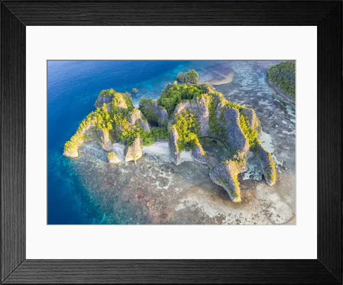 Framed Print : Limestone islands in Raja Ampat, Indonesia, are surrounded by healthy coral reefs. This biodiverse region is known as the heart of the Coral Triangle Framed Print : Limestone islands in Raja Ampat, Indonesia, are surrounded by healthy coral reefs. This biodiverse region is known as the heart of the Coral Triangle
