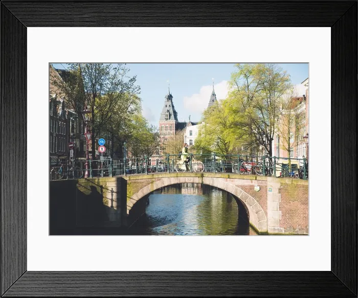 Framed Print : Amsterdam people riding bicycles in historical part in Amsterdam, Netherlands