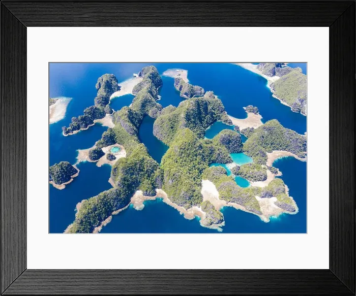 Framed Print : Shallow coral reefs surround remote limestone islands in Raja Ampat, Indonesia. This biodiverse region is known as the heart of the Coral Triangle Framed Print : Shallow coral reefs surround remote limestone islands in Raja Ampat, Indonesia. This biodiverse region is known as the heart of the Coral Triangle