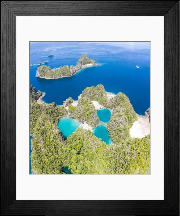 Framed Print : Shallow coral reefs surround remote limestone islands in Raja Ampat, Indonesia. This biodiverse region is known as the heart of the Coral Triangle Framed Print : Shallow coral reefs surround remote limestone islands in Raja Ampat, Indonesia. This biodiverse region is known as the heart of the Coral Triangle
