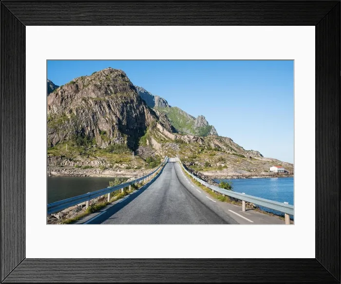 Framed Print : Straight asphalt road with mountain and sea against blue sky in Lofoten, Norway Framed Print : Straight asphalt road with mountain and sea against blue sky in Lofoten, Norway